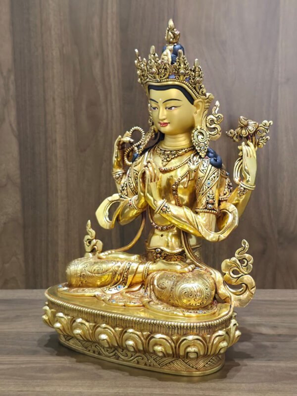 Left-facing view of four-armed Chenrezig statue showing the lotus, joined hands and ornate lotus pedestal.