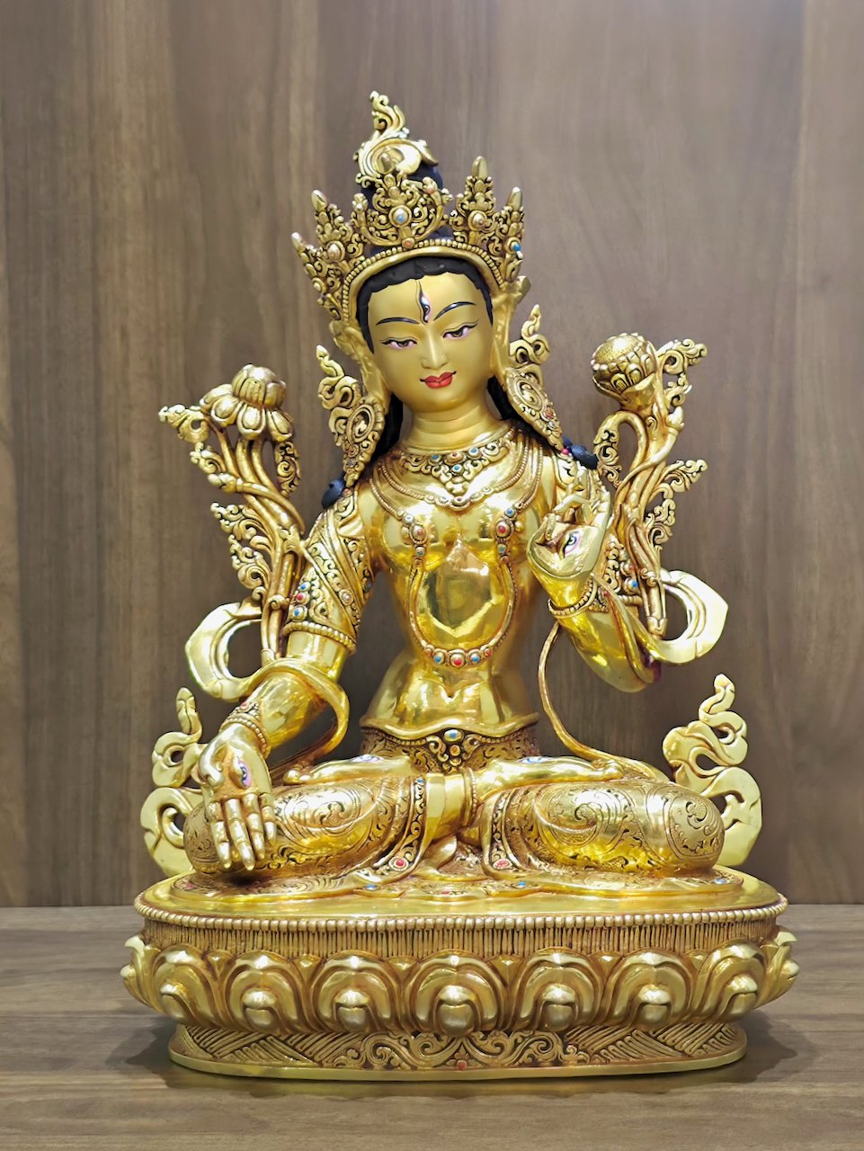 Alternate front view of the White Tara Buddhist statue in 24K gold plated copper, with an ornate crown, lotus flowers and patterned garments