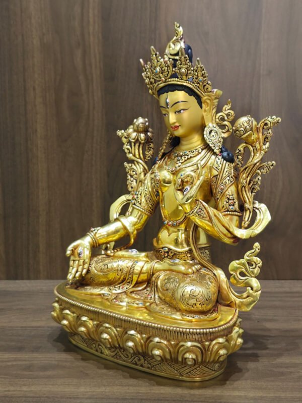 White Tara statue in 24K gold plated copper, left-facing angled view showing the ornate crown, lotus flowers and seated posture.